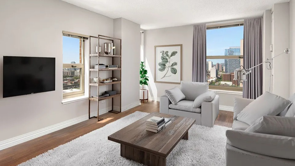 Bright living room at 100 W Chestnut in Chicago featuring city views, wall-mounted TV, open shelving, plush rug, and contemporary seating