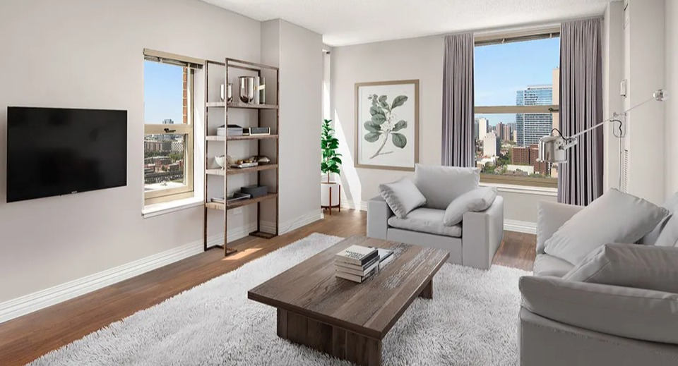 Bright living room at 100 W Chestnut in Chicago featuring city views, wall-mounted TV, open shelving, plush rug, and contemporary seating