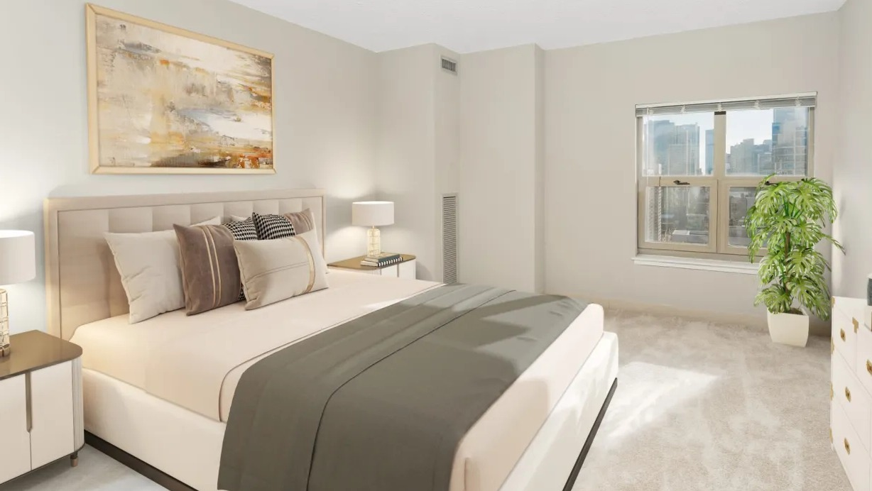 Serene primary bedroom at 100 W Chestnut in Chicago with upholstered bed, matching nightstands, soft neutral decor, and a window with skyline views