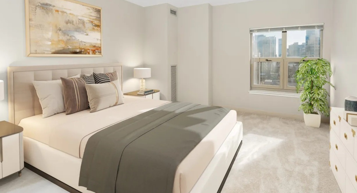 Serene primary bedroom at 100 W Chestnut in Chicago with upholstered bed, matching nightstands, soft neutral decor, and a window with skyline views