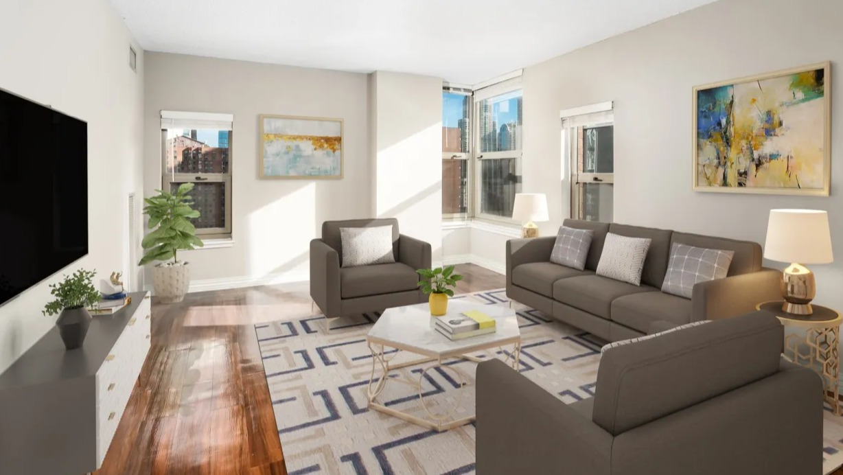 Spacious living room at 100 W Chestnut in Chicago featuring corner windows, modern sofa set, wall-mounted TV, and abundant natural light
