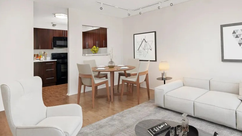 Modern living room at 1000 N LaSalle in Chicago with white sofa, dining area, wood floors, and open kitchen with dark cabinetry