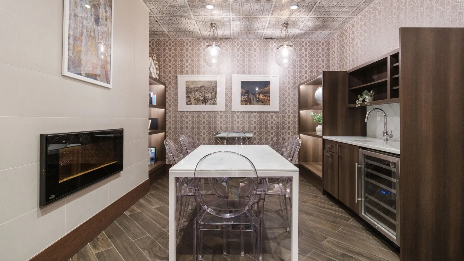Elegant private dining room with fireplace, patterned walls, marble table, and wet bar with wine fridge at 1000 South Clark in Chicago
