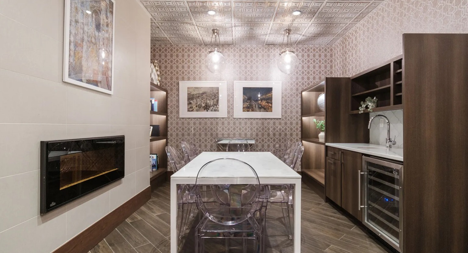 Elegant private dining room with fireplace, patterned walls, marble table, and wet bar with wine fridge at 1000 South Clark in Chicago