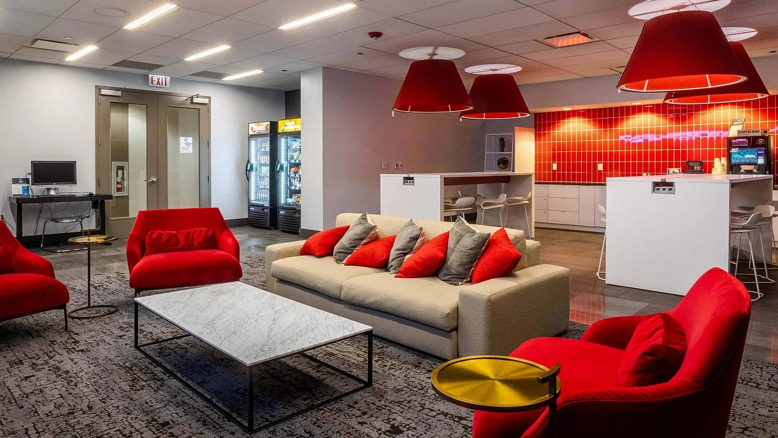 Bright resident café with coffee bar, lounge seating, and modern décor at 1000 South Clark apartments in Chicago