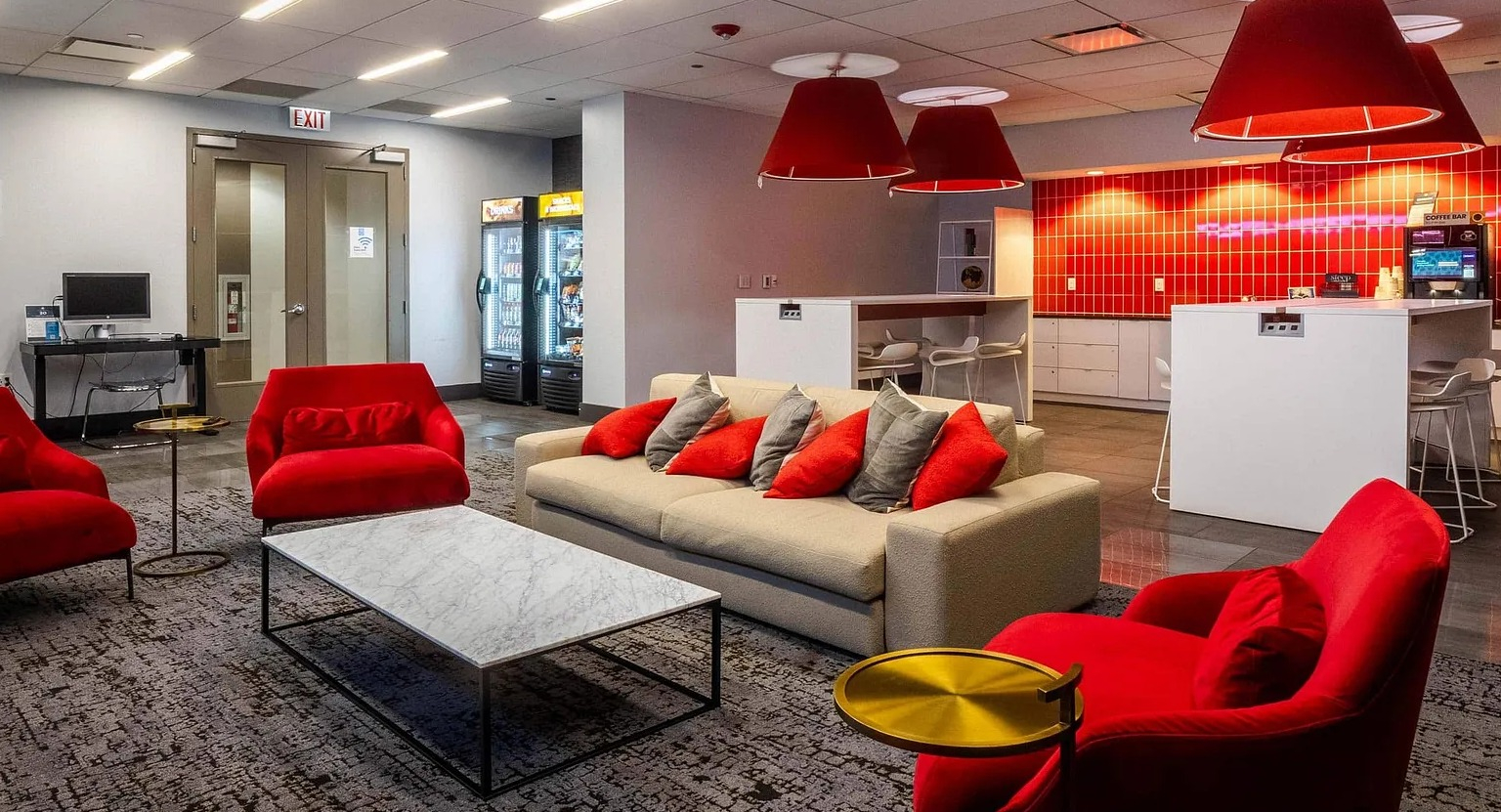 Bright resident café with coffee bar, lounge seating, and modern décor at 1000 South Clark apartments in Chicago