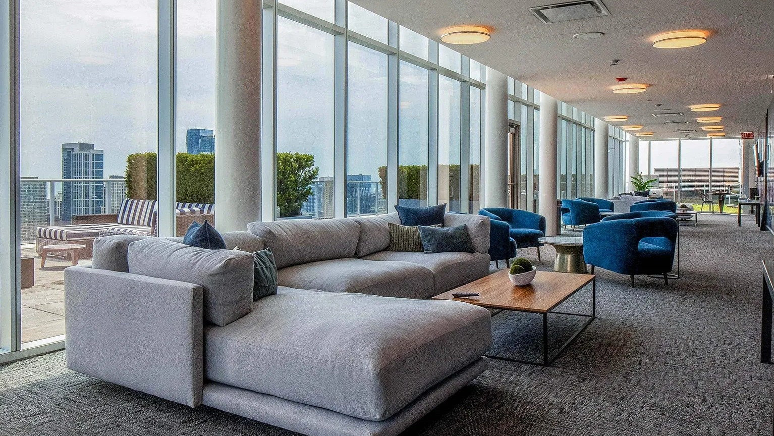 Stylish sky lounge with plush seating, floor-to-ceiling windows, and access to outdoor terrace overlooking the Chicago skyline at 1000 South Clark