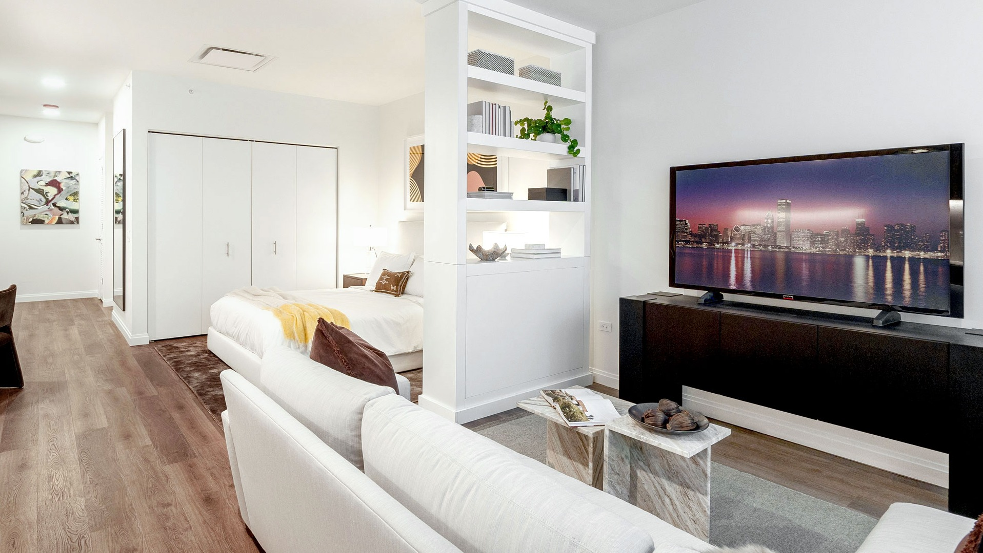 Convertible apartment with open floor plan, modern kitchen, cozy living area, and sleeping nook at 1000M Apartments in Chicago