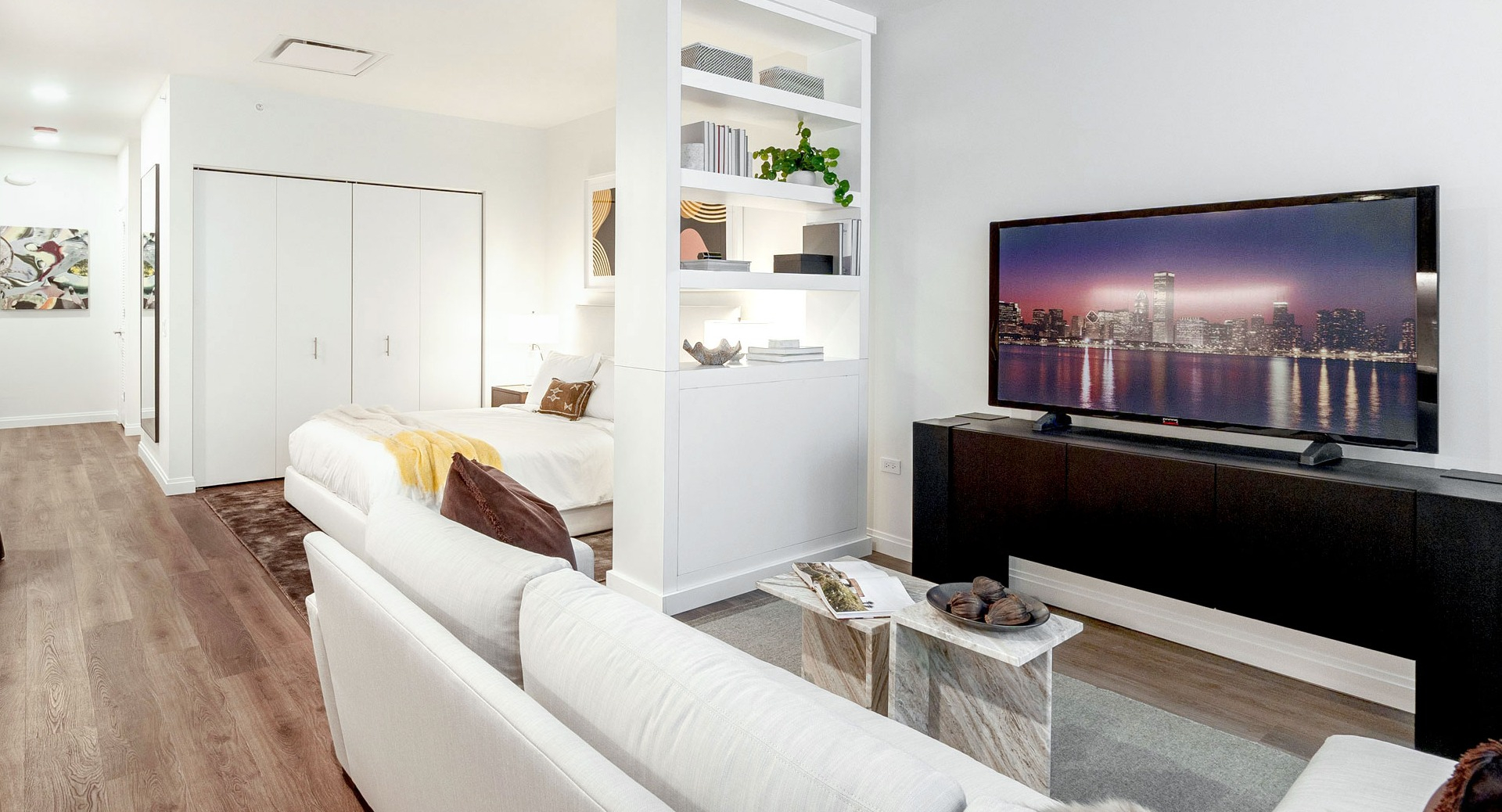 Convertible apartment with open floor plan, modern kitchen, cozy living area, and sleeping nook at 1000M Apartments in Chicago