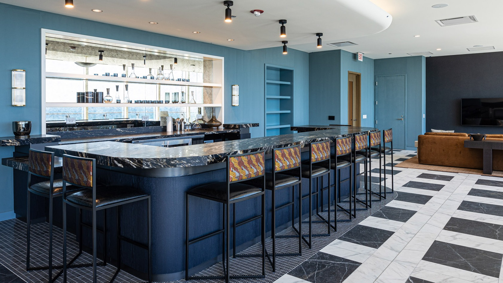 Stylish Harbor Bar featuring a sleek marble counter, barstool seating, and modern finishes at 1000M Apartments in Chicago