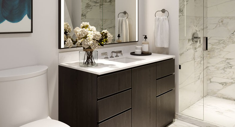 Modern bathroom with marble tile floors, glass shower, and dark vanity at 1000M Apartments in Chicago