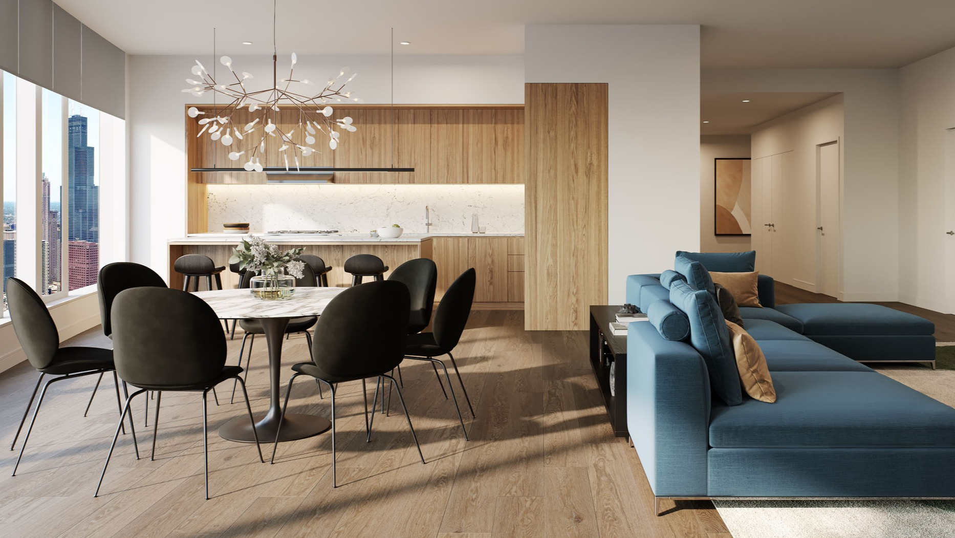 Open concept apartment with wood kitchen, dining table, and blue sectional sofa at 1000M Apartments in Chicago