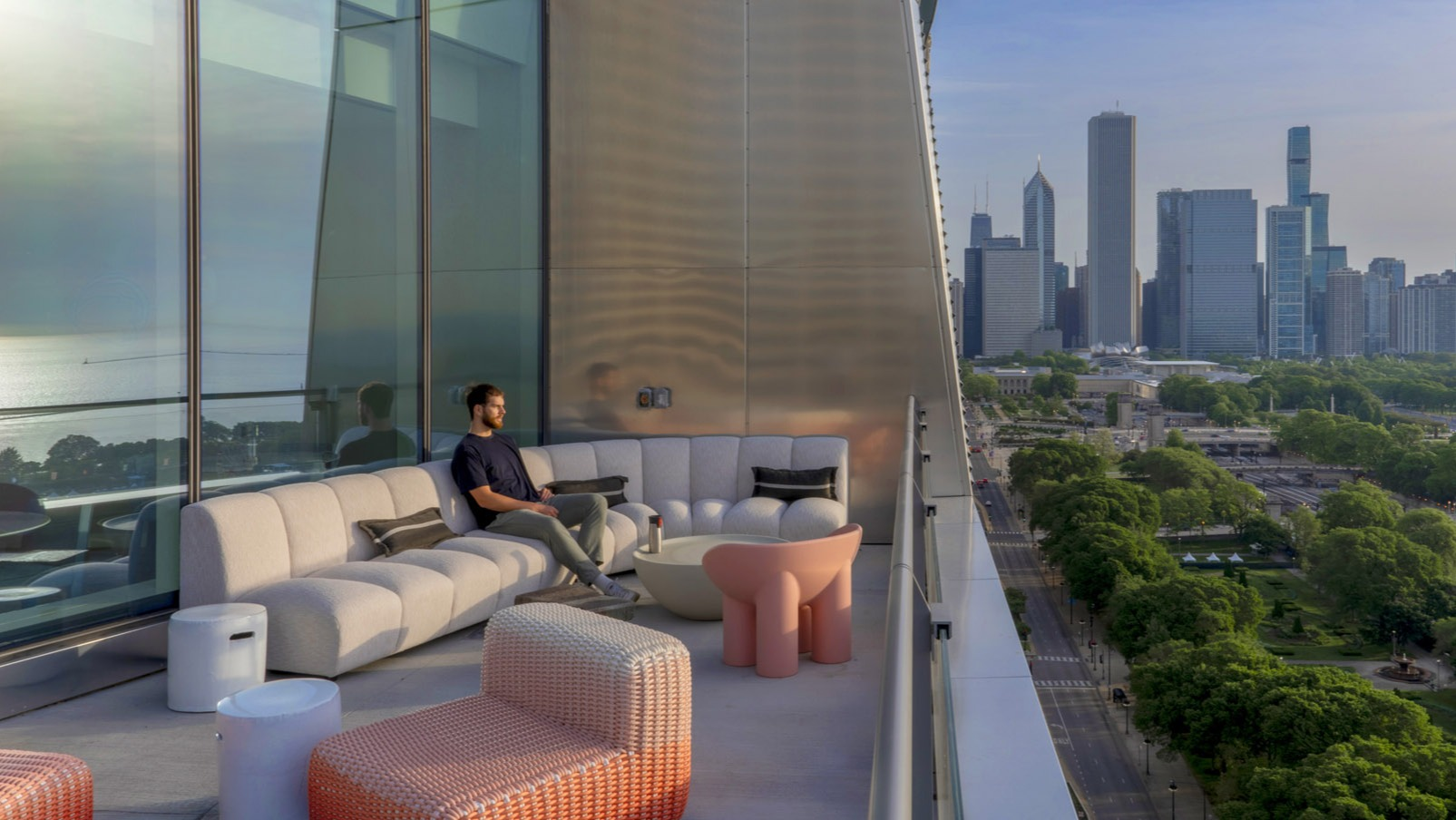 Elegant terrace lounge with modern outdoor furniture and sweeping Lake Michigan and skyline views at 1000M Apartments in Chicago