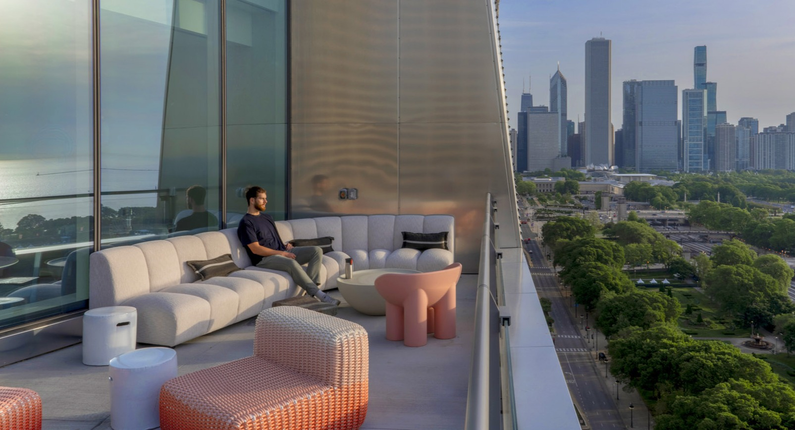 Elegant terrace lounge with modern outdoor furniture and sweeping Lake Michigan and skyline views at 1000M Apartments in Chicago