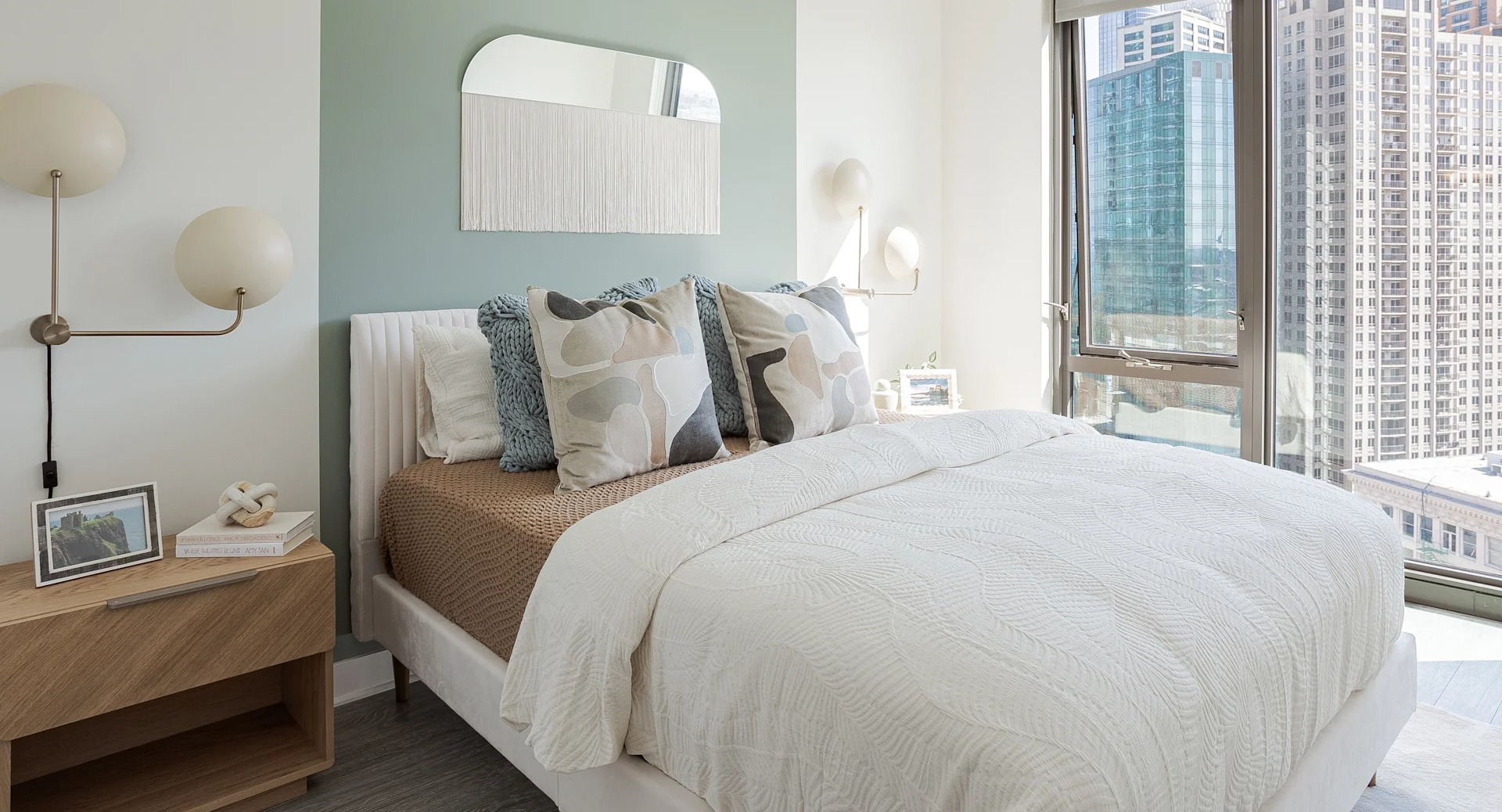 Bright modern bedroom with floor-to-ceiling windows, city views, and stylish décor at 1001 South State apartments in Chicago