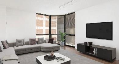Bright living room with sectional seating, wall-mounted TV, and floor-to-ceiling windows at 1100 North Dearborn apartments in Chicago