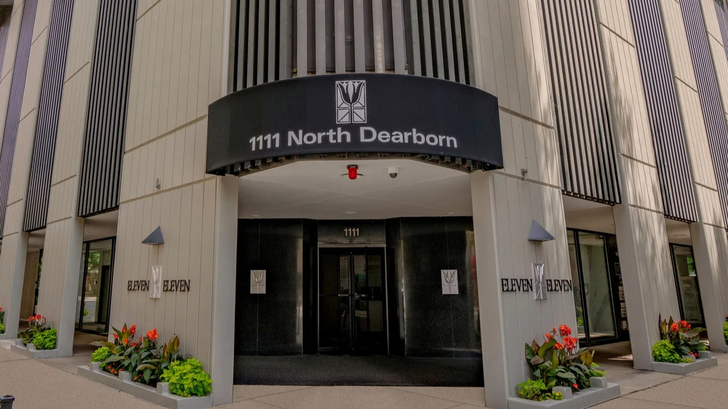 Welcoming entrance at 1111 N Dearborn in Chicago’s Gold Coast, featuring a canopy and landscaped planters—steps from neighborhood dining, shopping, and transit