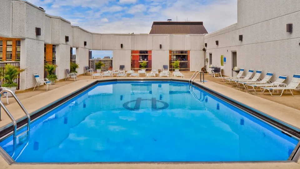 Rooftop pool at 1111 N Dearborn with lounge chairs and city views—relaxing outdoor amenity for residents seeking a Gold Coast Chicago apartment lifestyle
