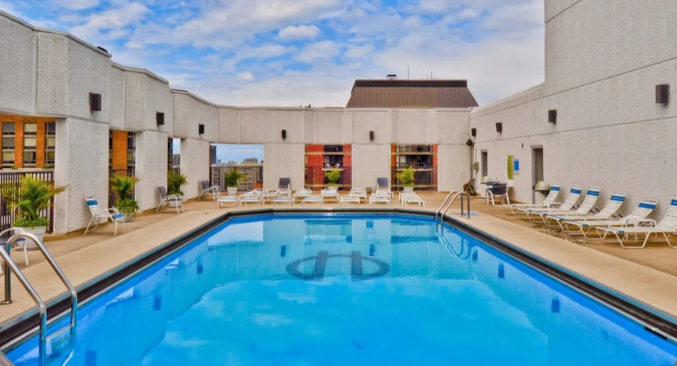 Rooftop pool at 1111 N Dearborn with lounge chairs and city views—relaxing outdoor amenity for residents seeking a Gold Coast Chicago apartment lifestyle