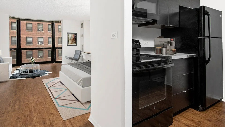Open studio layout at 1111 N Dearborn showcasing a modern kitchen beside a bright sleeping and living area with large windows—smart use of space in Chicago