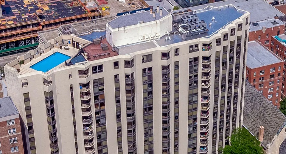 Aerial view of 1120 N LaSalle apartments in Chicago, showcasing the high-rise exterior, private balconies, and a rooftop pool