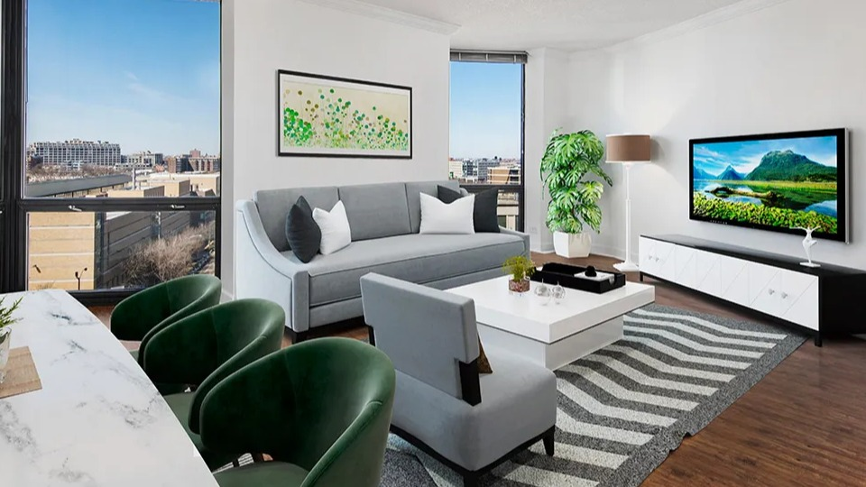 Corner living room with modern furniture, marble table, and floor-to-ceiling windows showcasing city views at 1120 N LaSalle apartments