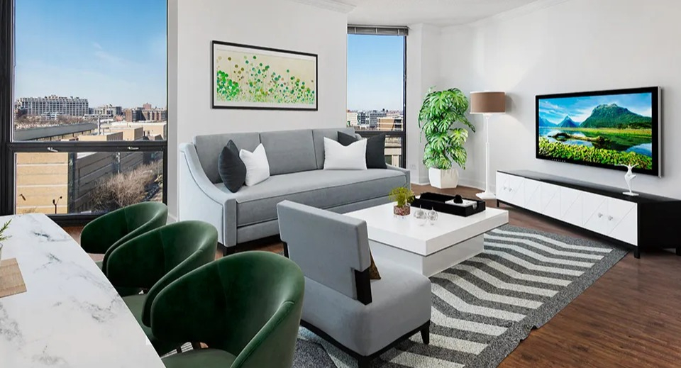 Corner living room with modern furniture, marble table, and floor-to-ceiling windows showcasing city views at 1120 N LaSalle apartments