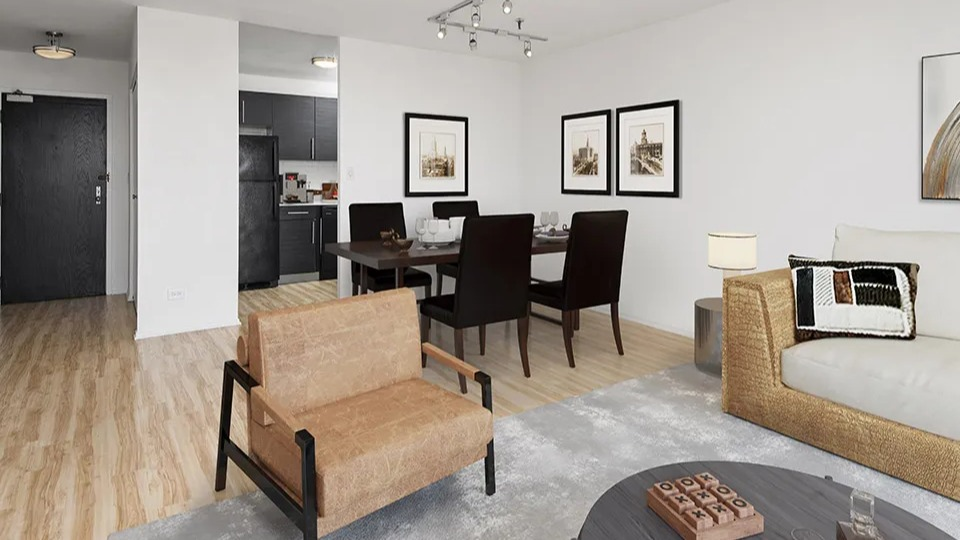 Open-concept living and dining space with modern furniture, framed art, and kitchen view at 1120 N LaSalle apartments in Chicago