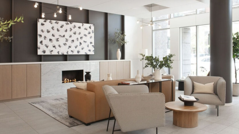 Sophisticated lobby lounge with fireplace, modern seating, and floor-to-ceiling windows at 1225 Old Town Apartments in Chicago