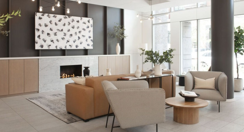 Sophisticated lobby lounge with fireplace, modern seating, and floor-to-ceiling windows at 1225 Old Town Apartments in Chicago