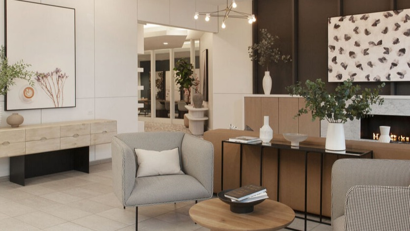 Inviting lobby seating area with designer lighting, marble fireplace, and styled consoles at 1225 Old Town Apartments in Chicago