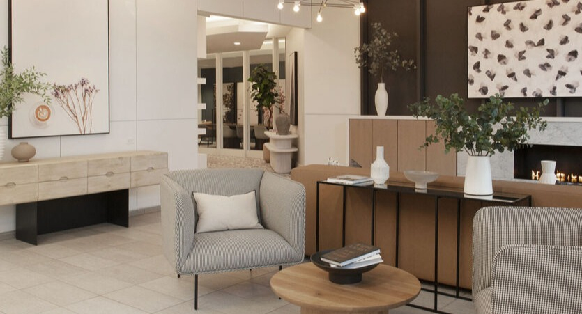 Inviting lobby seating area with designer lighting, marble fireplace, and styled consoles at 1225 Old Town Apartments in Chicago