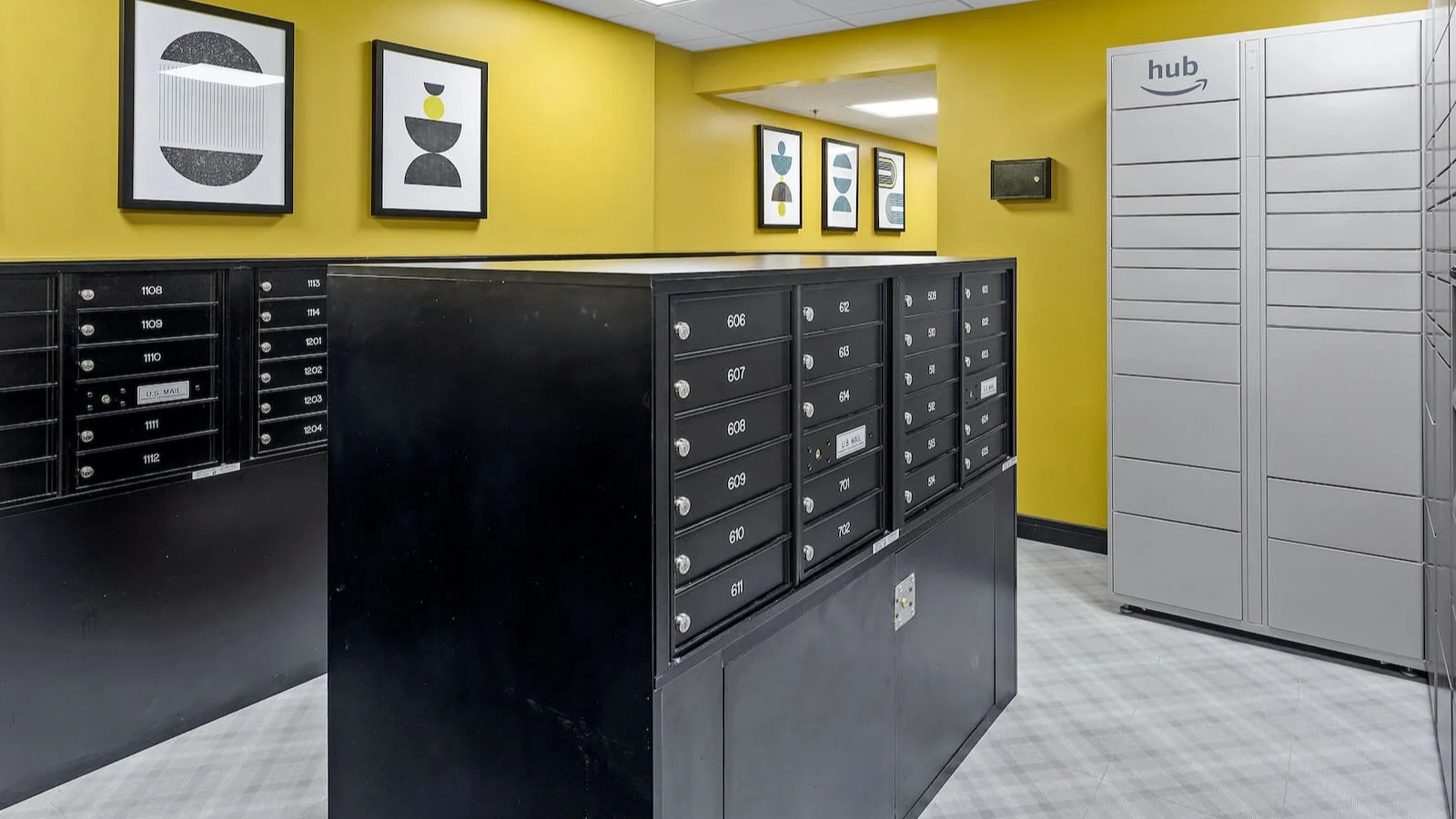 Package room at 1250 LaSalle in Chicago with Amazon Hub lockers, secure mailboxes, and bold yellow walls accented by framed modern artwork