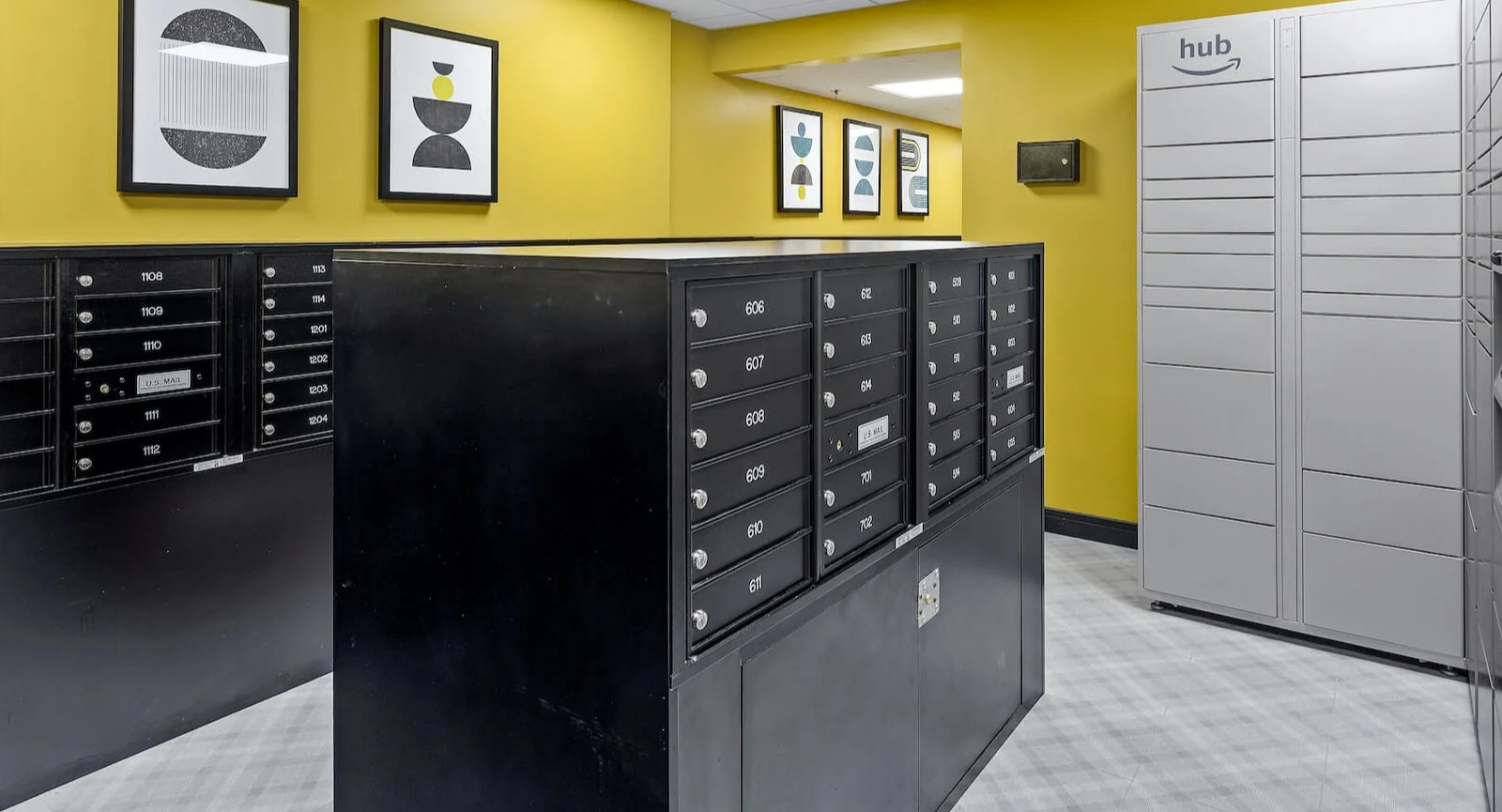 Package room at 1250 LaSalle in Chicago with Amazon Hub lockers, secure mailboxes, and bold yellow walls accented by framed modern artwork