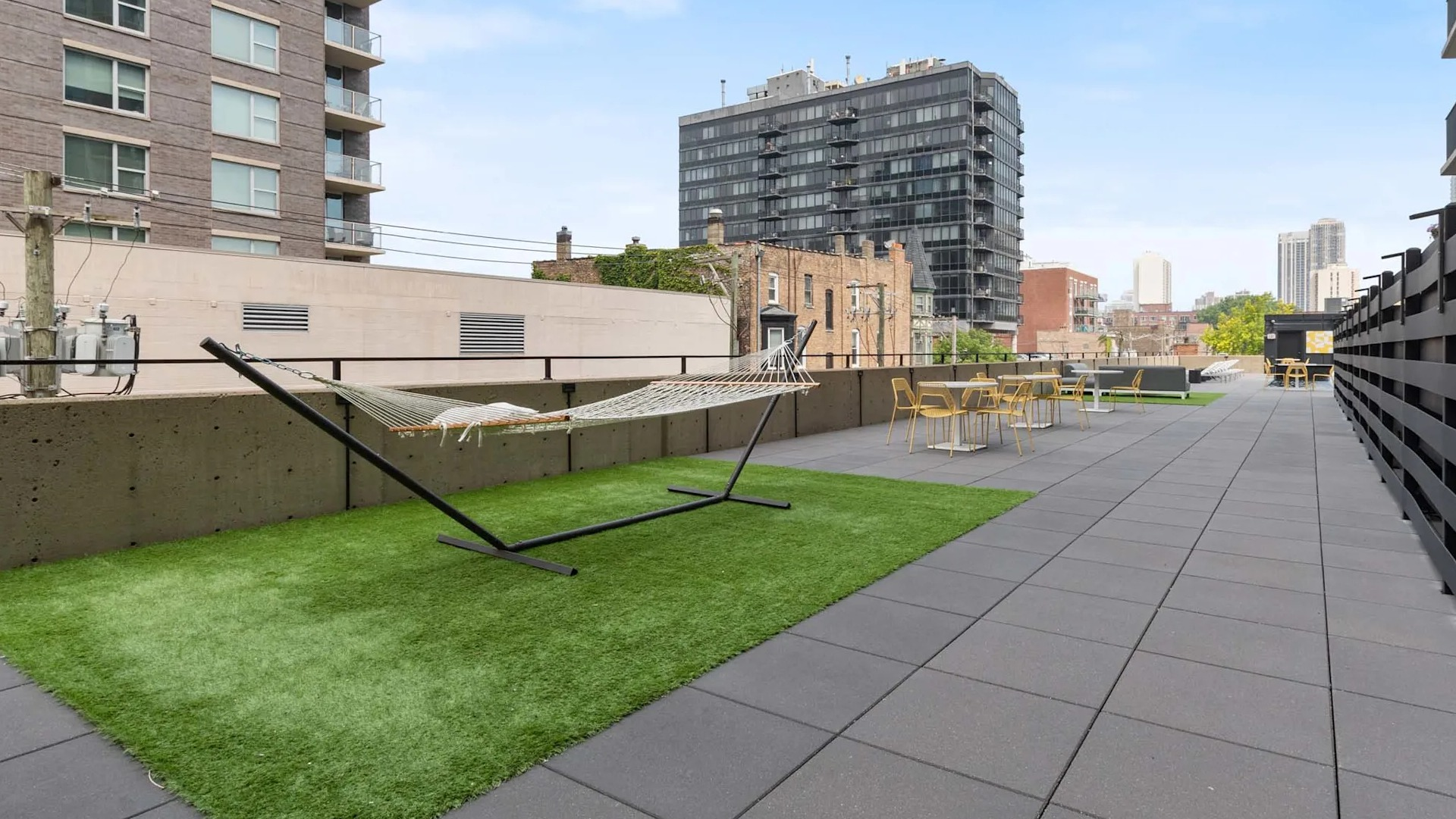 Rooftop hammock lawn at 1250 LaSalle in Chicago with turf, outdoor seating areas, and neighborhood views—ideal for relaxing or working outside