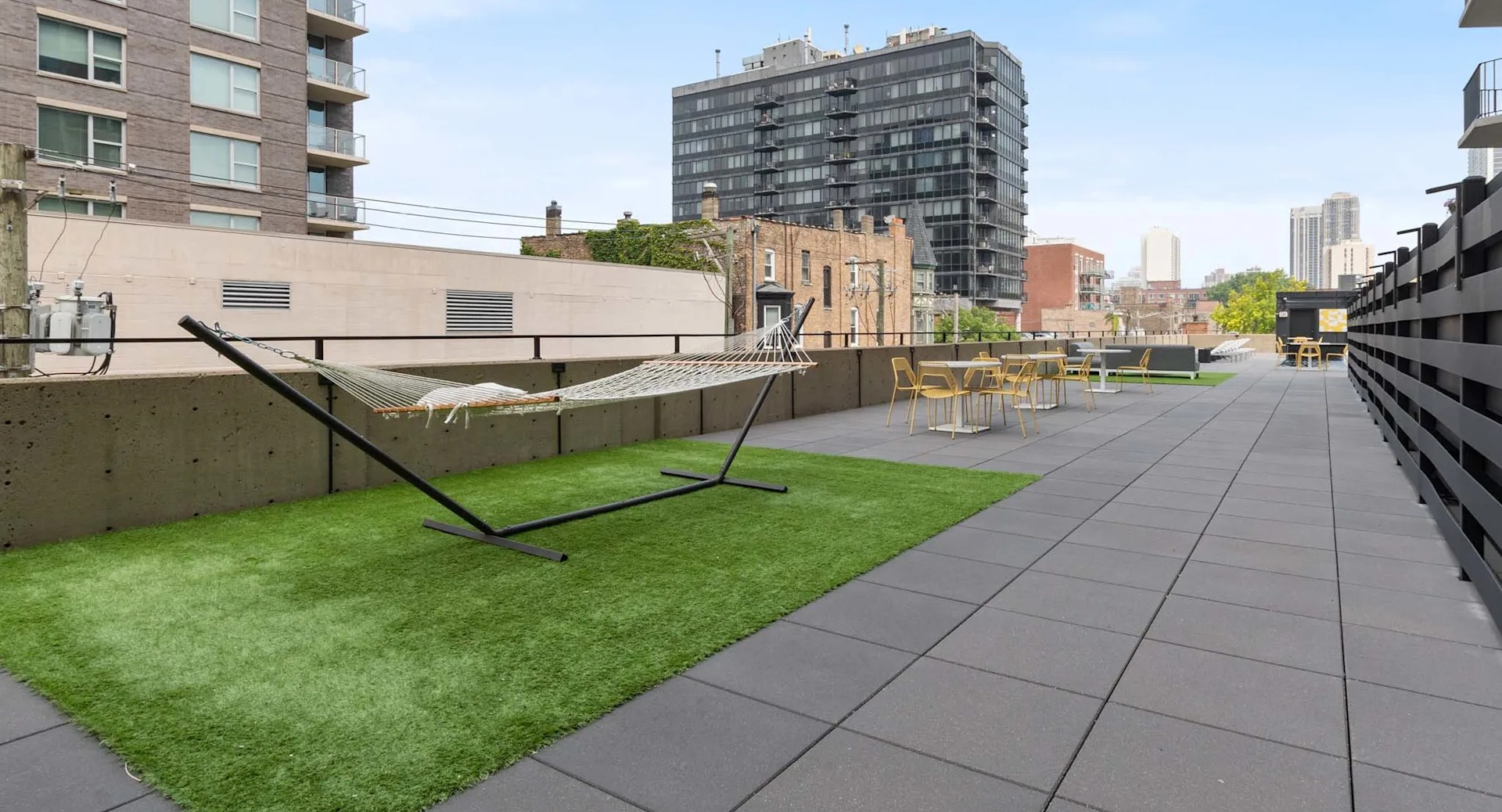 Rooftop hammock lawn at 1250 LaSalle in Chicago with turf, outdoor seating areas, and neighborhood views—ideal for relaxing or working outside