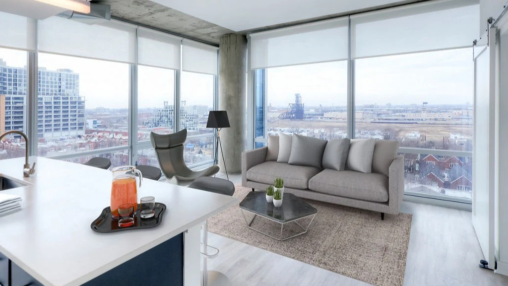 Bright living room at 1401 S. State Apartments in Chicago, featuring an open-concept layout, modern furniture, and expansive city views