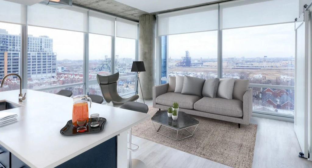 Bright living room at 1401 S. State Apartments in Chicago, featuring an open-concept layout, modern furniture, and expansive city views