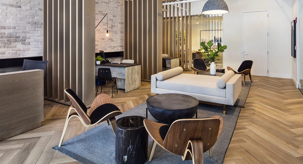 Chic lobby seating area at 1401 S. State Apartments in Chicago, featuring stylish furniture, wooden accents, and a reception desk