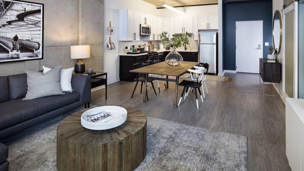 Open-concept living space at 1401 S. State Apartments in Chicago, featuring a modern living room, dining area, and kitchen