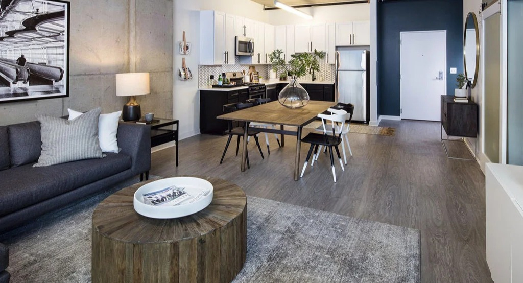 Open-concept living space at 1401 S. State Apartments in Chicago, featuring a modern living room, dining area, and kitchen