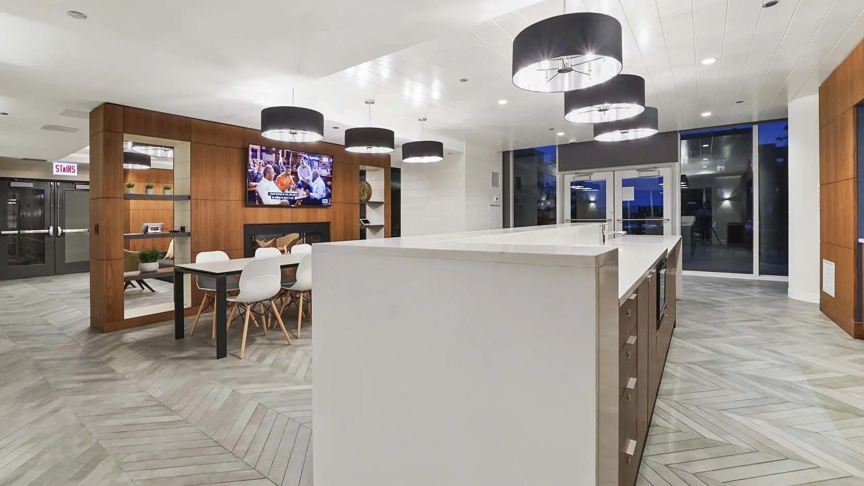 Spacious amenity kitchen with extra-long island, multiple pendants, and an adjacent dining area at 1407 on Michigan apartments in Chicago