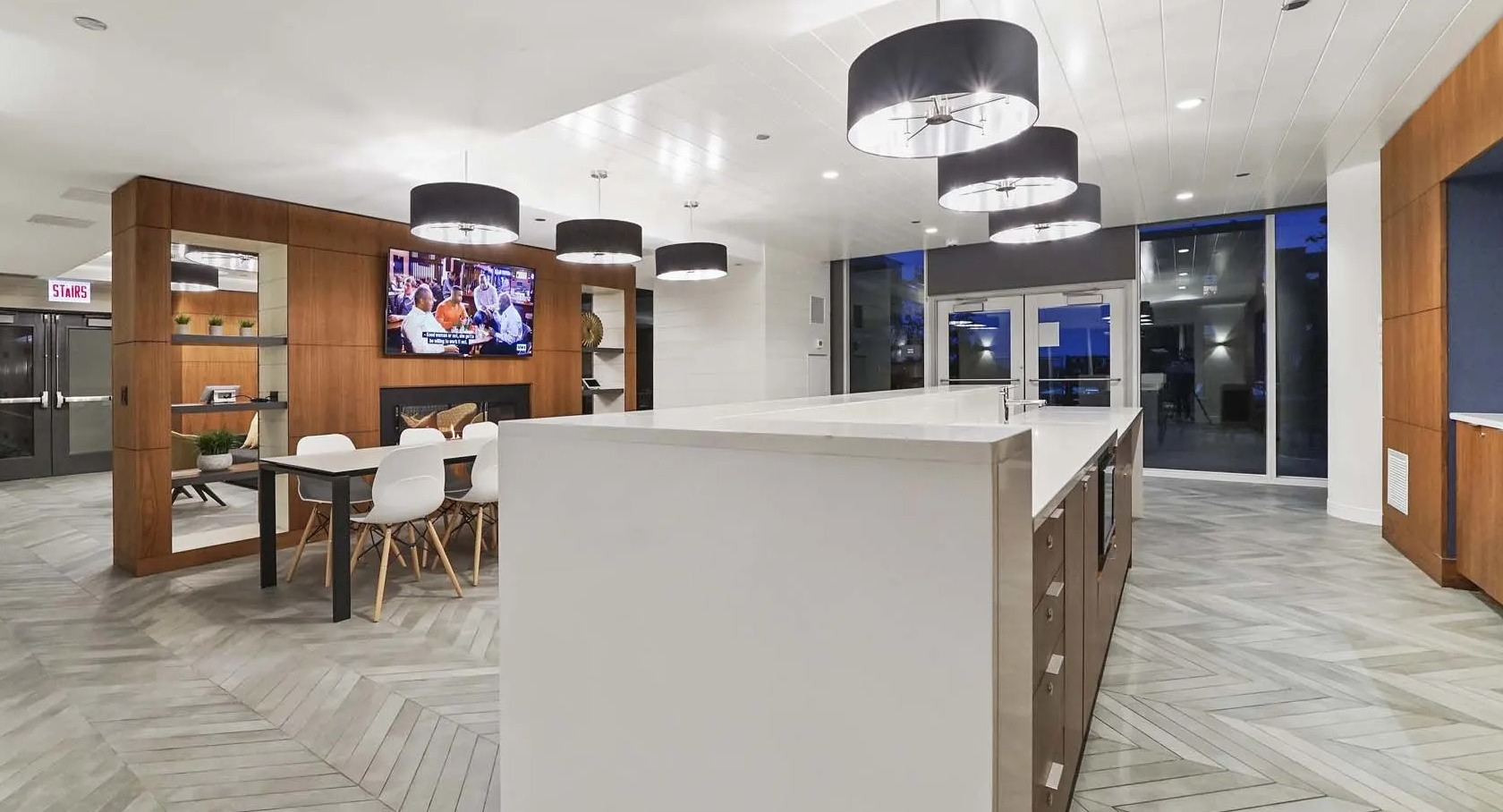 Spacious amenity kitchen with extra-long island, multiple pendants, and an adjacent dining area at 1407 on Michigan apartments in Chicago
