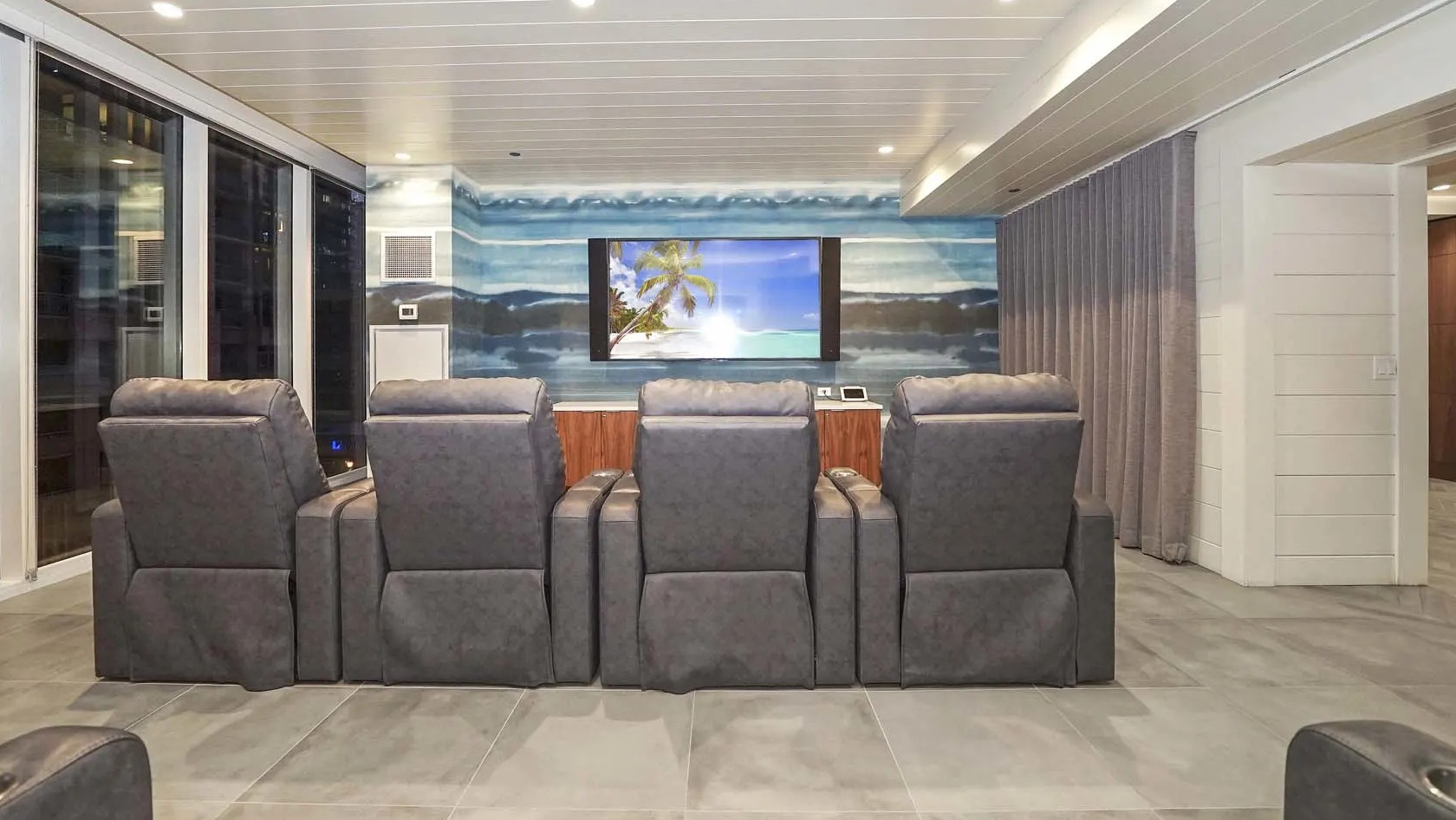 Private theater with plush recliners, big screen, and dimmable lighting at 1407 on Michigan apartments in Chicago