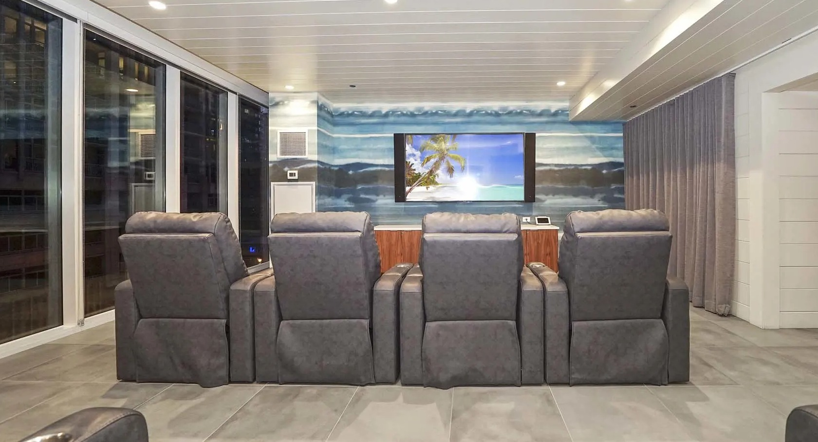 Private theater with plush recliners, big screen, and dimmable lighting at 1407 on Michigan apartments in Chicago