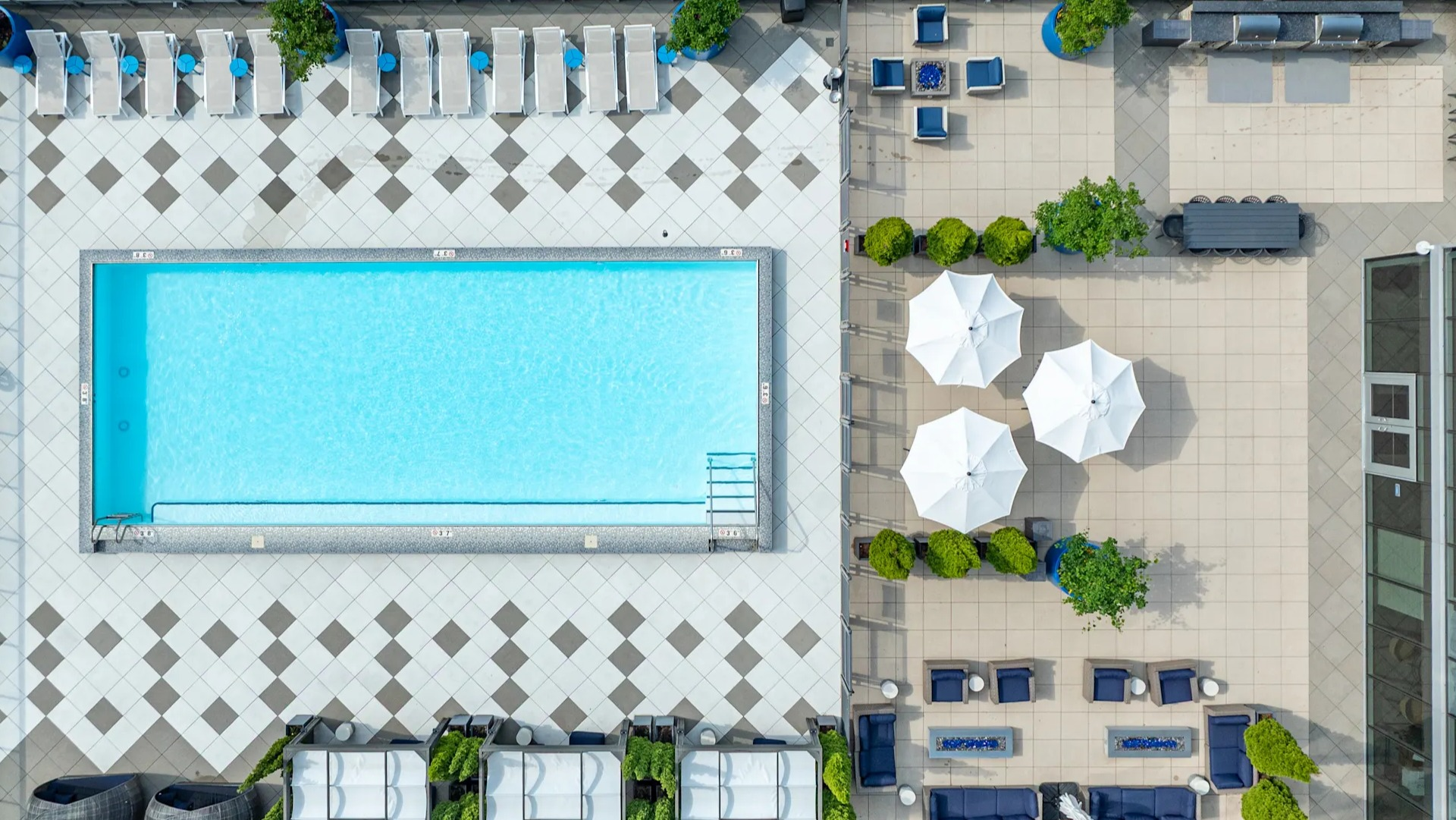 Aerial view of the rooftop pool, cabanas, grilling stations, and lounge areas at 1407 on Michigan apartments in Chicago