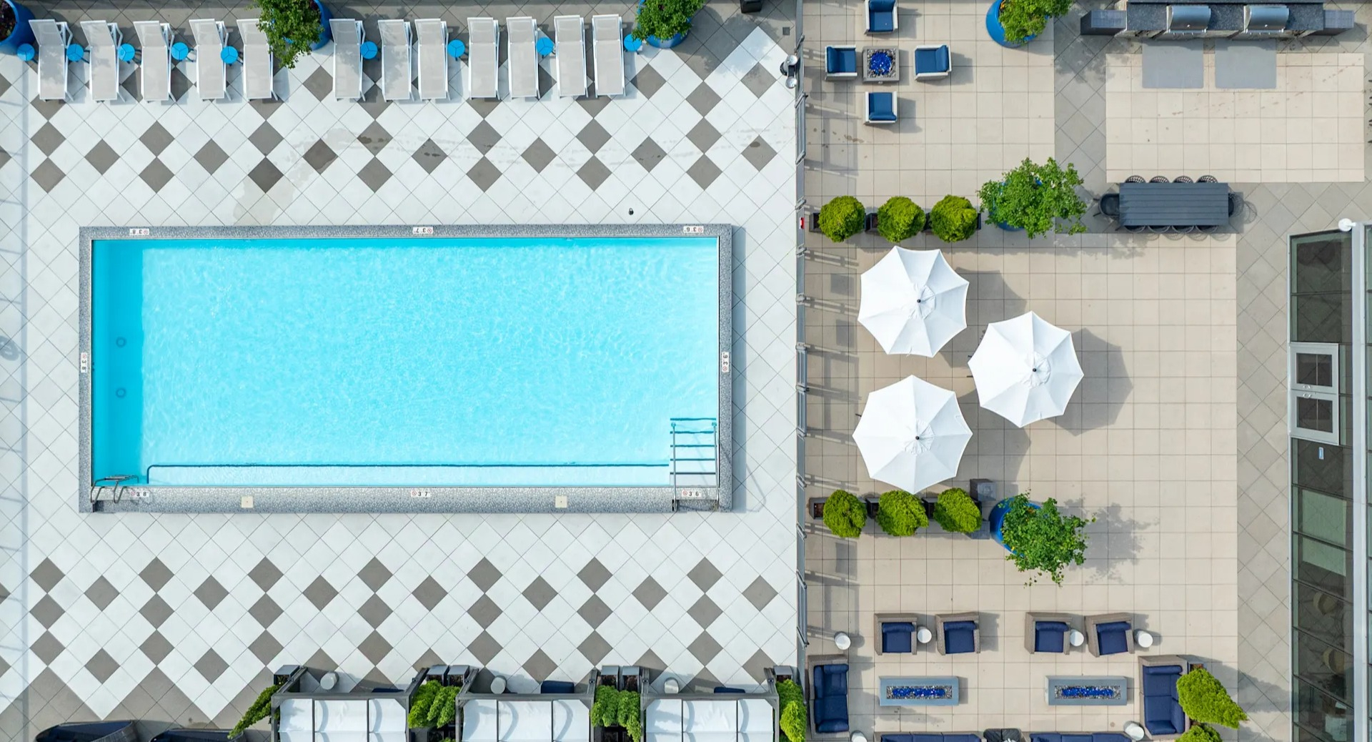 Aerial view of the rooftop pool, cabanas, grilling stations, and lounge areas at 1407 on Michigan apartments in Chicago