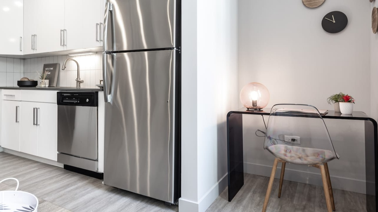 Modern kitchen at 330 S Wells Apartments in Chicago featuring stainless steel appliances and a small workspace with desk
