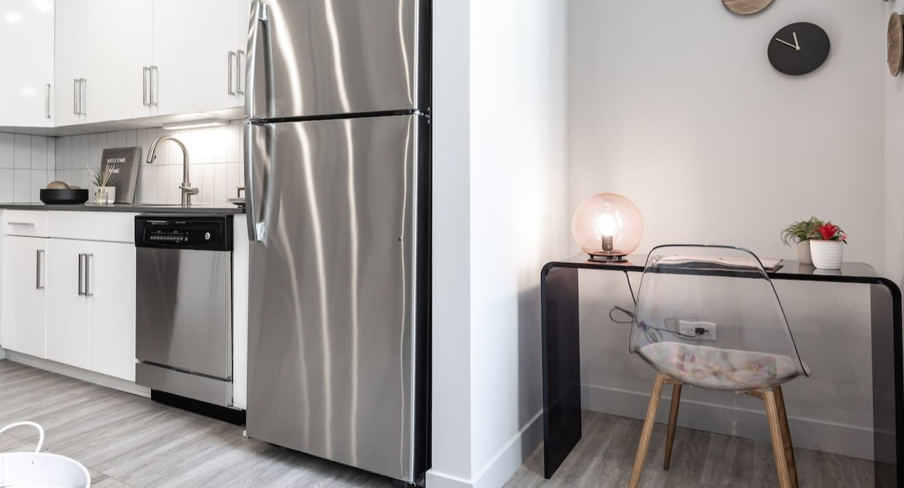 Modern kitchen at 330 S Wells Apartments in Chicago featuring stainless steel appliances and a small workspace with desk