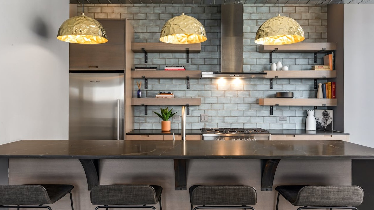 Skylounge kitchen at 330 S Wells Apartments in Chicago with pendant lights, bar seating, and open shelving